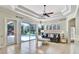 Bright living room featuring tile floors, tray ceilings with access to a screened pool at 8005 Royal Birkdale Cir, Lakewood Ranch, FL 34202