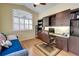 Well-appointed home office with built-in desk, cabinetry, and natural light from large window at 8005 Royal Birkdale Cir, Lakewood Ranch, FL 34202