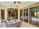 Outdoor patio with table and chairs, seamlessly connected to indoor spaces through sliding glass doors at 8005 Royal Birkdale Cir, Lakewood Ranch, FL 34202