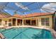 Outdoor pool area with screen enclosure, offering a serene and private space for relaxation at 8005 Royal Birkdale Cir, Lakewood Ranch, FL 34202