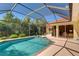 Beautiful pool area with mature trees, providing a relaxing outdoor experience at 8005 Royal Birkdale Cir, Lakewood Ranch, FL 34202