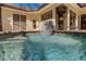 Inviting in-ground pool with a refreshing fountain, offering a tranquil oasis in the backyard at 8005 Royal Birkdale Cir, Lakewood Ranch, FL 34202