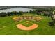 Aerial view of the community baseball fields near a lake and lush green trees at 803 Fairwaycove Ln # 102, Bradenton, FL 34212