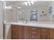 Bright bathroom featuring wood cabinets, a white countertop, and a walk-in shower with glass door at 803 Fairwaycove Ln # 102, Bradenton, FL 34212