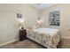 Cozy bedroom with a queen-sized bed, seashell-themed decor, neutral walls, and a sunlit window at 803 Fairwaycove Ln # 102, Bradenton, FL 34212