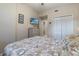 Bright bedroom featuring a beach themed bed, TV, dresser and storage space at 803 Fairwaycove Ln # 102, Bradenton, FL 34212