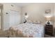 A comfortable bedroom featuring a beach themed bed, side tables, lamps, and a large closet at 803 Fairwaycove Ln # 102, Bradenton, FL 34212