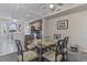 Stylish dining area featuring a glass-top table and views into the modern kitchen at 803 Fairwaycove Ln # 102, Bradenton, FL 34212