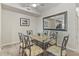 Dining room with seating for six, stylish decor, and a mirrored wall for an airy feel at 803 Fairwaycove Ln # 102, Bradenton, FL 34212