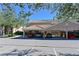 Attractive condo building showing attached covered parking and beautiful landscaping on a sunny day at 803 Fairwaycove Ln # 102, Bradenton, FL 34212