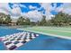 An outdoor game area with checkers, shuffleboard, and other games, with lush landscaping at 803 Fairwaycove Ln # 102, Bradenton, FL 34212