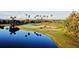 Scenic view of a pristine golf course with a tranquil lake and lush green surroundings at 803 Fairwaycove Ln # 102, Bradenton, FL 34212