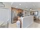 Bright, open kitchen with stainless steel appliances, wood cabinets, and eat-in dining space at 803 Fairwaycove Ln # 102, Bradenton, FL 34212