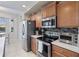Well-equipped kitchen featuring stainless steel appliances, ample cabinet space, and modern countertops, perfect for culinary enthusiasts at 803 Fairwaycove Ln # 102, Bradenton, FL 34212
