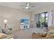 Comfortable living room with a ceiling fan, neutral color palette, and a sliding door to the outside patio at 803 Fairwaycove Ln # 102, Bradenton, FL 34212