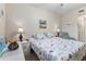Bright main bedroom features a queen-size bed, soft lighting, and calming decor at 803 Fairwaycove Ln # 102, Bradenton, FL 34212