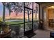 Screened patio offers serene views of the golf course and landscaping at sunset at 803 Fairwaycove Ln # 102, Bradenton, FL 34212