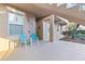 Outdoor patio space featuring dual chairs and views of lush landscaping and community sidewalks at 803 Fairwaycove Ln # 102, Bradenton, FL 34212