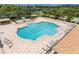 Large community pool features plenty of seating and shaded areas for residents to relax at 803 Fairwaycove Ln # 102, Bradenton, FL 34212
