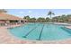 Inviting swimming pool with lane markers and poolside lounge area for relaxation and recreation at 803 Fairwaycove Ln # 102, Bradenton, FL 34212