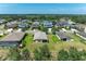Aerial view of a residential neighborhood with well-maintained homes and a scenic pond at 9819 46Th E Ct, Parrish, FL 34219