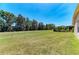 Expansive backyard with lush lawn and view of surrounding trees and landscaping at 9819 46Th E Ct, Parrish, FL 34219