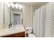 Bathroom with mirror, single sink and shower/tub with black and white curtain at 9819 46Th E Ct, Parrish, FL 34219