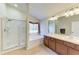 Bathroom with glass enclosed shower, soaker tub, double vanity sinks and tile flooring at 9819 46Th E Ct, Parrish, FL 34219