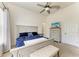 Spacious bedroom features a ceiling fan, plush carpet, and a comfortable bed at 9819 46Th E Ct, Parrish, FL 34219