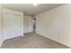 Empty bedroom featuring a double closet door and light neutral walls and carpet at 9819 46Th E Ct, Parrish, FL 34219