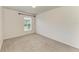 Neutral bedroom features carpet and a bright window providing natural light at 9819 46Th E Ct, Parrish, FL 34219