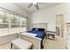 Bright bedroom with large window, ceiling fan, neutral carpet, and white furniture at 9819 46Th E Ct, Parrish, FL 34219
