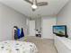 Bright bedroom with ceiling fan, closet, and television at 9819 46Th E Ct, Parrish, FL 34219