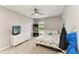 Comfortable bedroom with ceiling fan, tv, shelving and large window at 9819 46Th E Ct, Parrish, FL 34219