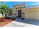 Inviting home with stone accents, a two-car garage, and a well-maintained front yard at 9819 46Th E Ct, Parrish, FL 34219