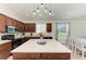 Bright kitchen featuring a large island, updated appliances, and a cozy dining area at 9819 46Th E Ct, Parrish, FL 34219