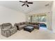 Comfortable living room features a ceiling fan and sliding glass doors to a patio at 9819 46Th E Ct, Parrish, FL 34219