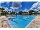 Community pool featuring clear blue water, surrounding lounge chairs, and a refreshing atmosphere at 9819 46Th E Ct, Parrish, FL 34219