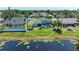 An aerial view showing the home is near the lake and features a screened pool, enhancing its outdoor appeal at 1008 83Rd Nw St, Bradenton, FL 34209