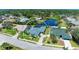 An aerial view shows the property's proximity to a pond, complemented by a screened pool and a well-manicured lawn at 1008 83Rd Nw St, Bradenton, FL 34209