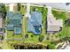 An aerial view showcases the home with its screened-in pool, alongside a serene pond and lush backyard at 1008 83Rd Nw St, Bradenton, FL 34209