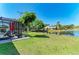Enjoy the backyard view, complete with a screened-in pool area and a picturesque pond beyond the green lawn at 1008 83Rd Nw St, Bradenton, FL 34209