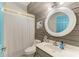 Cozy bathroom with shiplap walls, modern vanity, stylish mirror, and a shower with curtains at 1008 83Rd Nw St, Bradenton, FL 34209