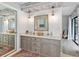 Bright bathroom with double sinks, gray cabinets, shiplap accent wall, and modern fixtures at 1008 83Rd Nw St, Bradenton, FL 34209