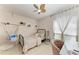 Cozy bedroom with a comfortable bed, a hanging chair, a window with lots of light, and tile floors at 1008 83Rd Nw St, Bradenton, FL 34209