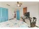 A cheerful bedroom complete with Peloton, keyboard, and ceiling fan at 1008 83Rd Nw St, Bradenton, FL 34209