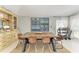 Elegant dining space featuring a long wooden table, seating for eight, and stylish decor, creating a warm ambiance at 1008 83Rd Nw St, Bradenton, FL 34209