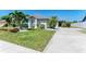 Well-maintained house with lawn, white rock landscaping, mature trees and long driveway at 1008 83Rd Nw St, Bradenton, FL 34209