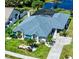 Aerial view of landscaped single-Gathering home with blue roof and manicured lawn at 1008 83Rd Nw St, Bradenton, FL 34209