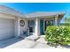Welcoming front entrance features a bright blue door and lovely landscaping at 1008 83Rd Nw St, Bradenton, FL 34209